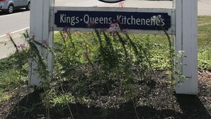 A sign for The Towne Motel with a logo and text indicating it offers Kings, Queens, and Kitchener's services. - The Towne Motel (Skowhegan)