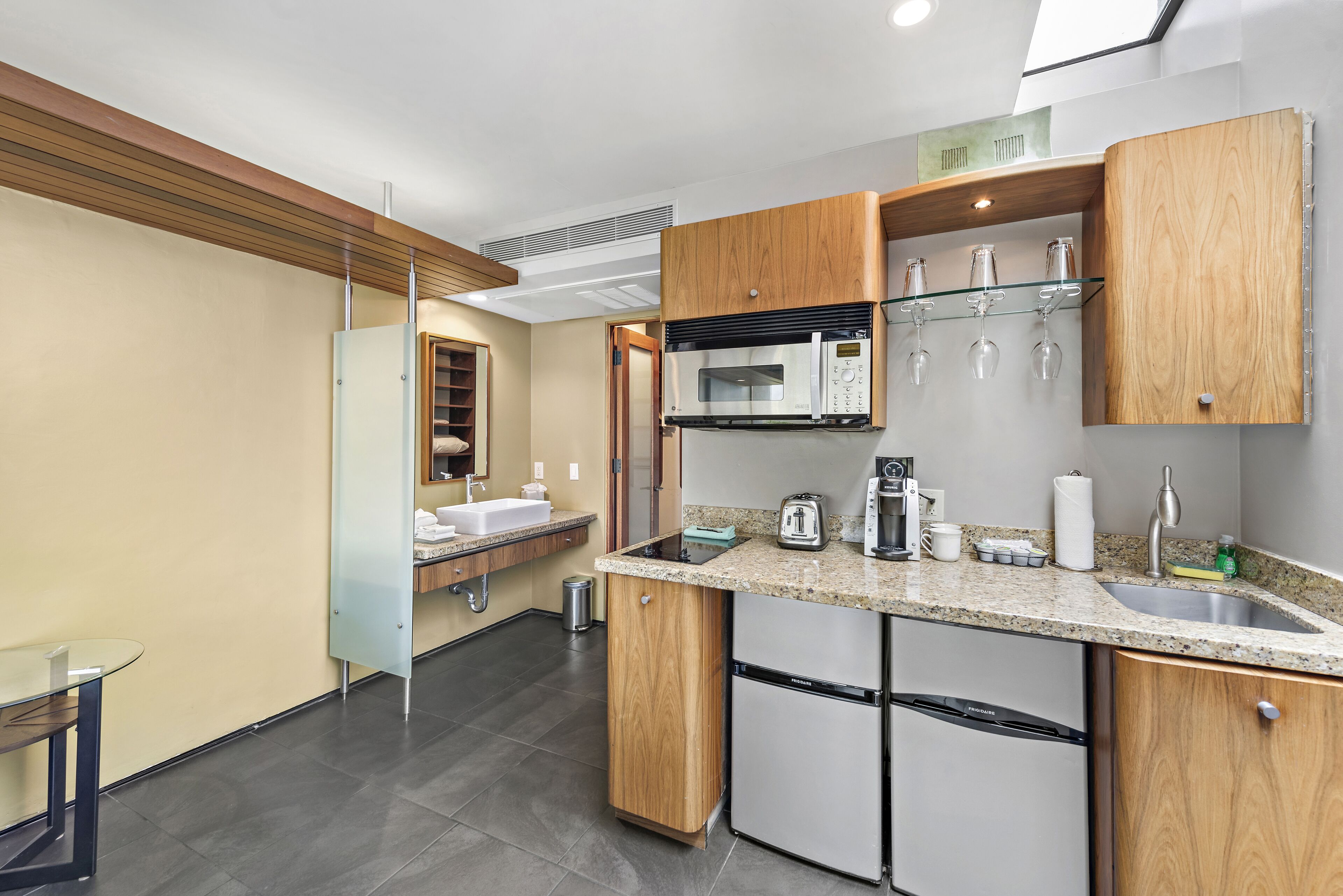 A modern kitchen with a microwave, toaster, and sink.