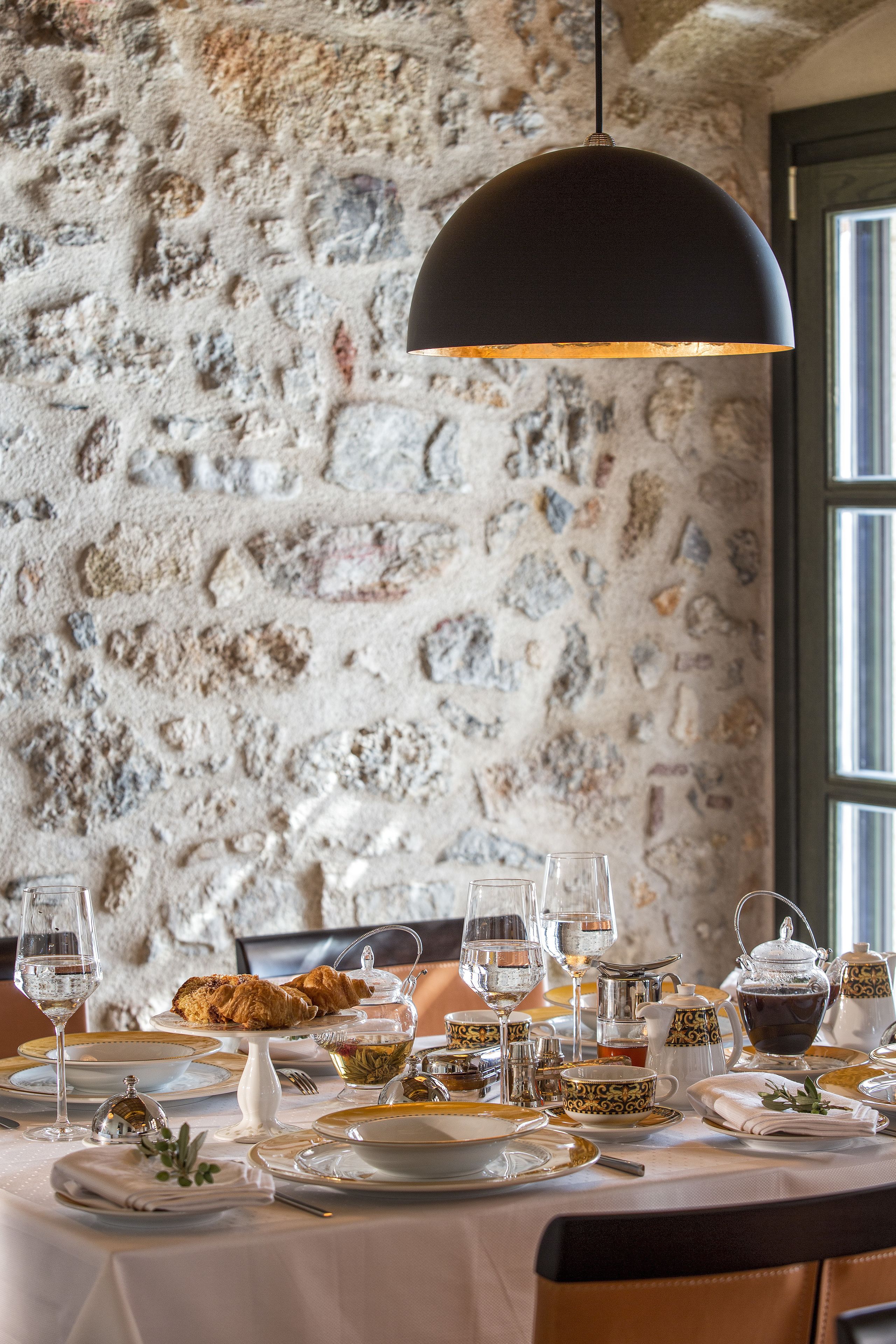 A table set for a meal with a stone wall background.