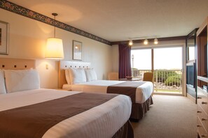 A hotel room with two beds, a large window with a view, and a balcony. - Hi-Tide Oceanfront Inn (Seaside)