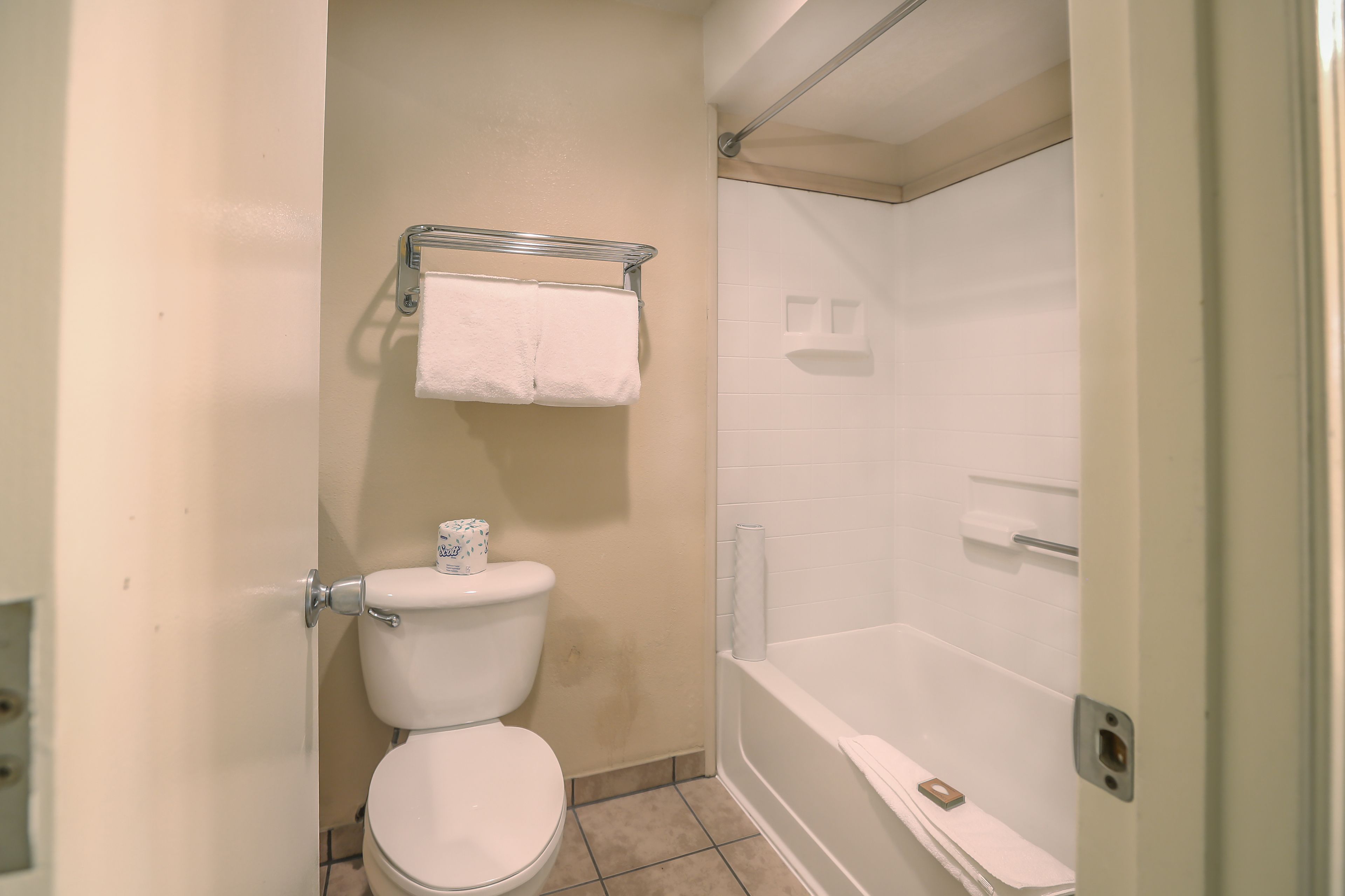 A bathroom with a toilet, a shower, and a bathtub.