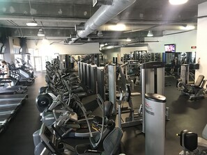 A gym with treadmills, ellipticals, and weight machines.