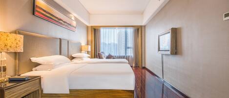 A hotel room with a large bed, bedside tables, a lamp, a painting on the wall, and a window with curtains.