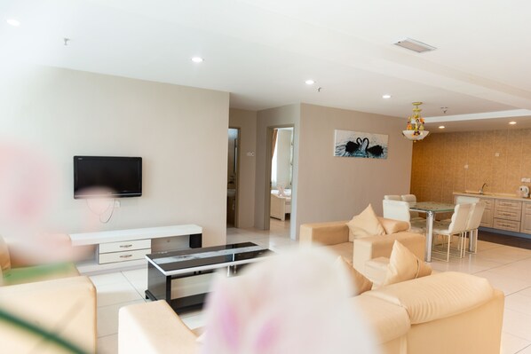 Family Suite, 4 Bedrooms | Living area | Flat-screen TV
