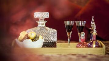 A decanter, two glasses, and a bottle of wine on a wooden tray.