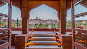 A view from a room with a marble floor and a set of stairs leading to an outdoor area. There are lanterns placed on the steps, and a clear view of the surrounding landscape. - Bijolai Palace - A Inde Hotel Jodhpur (Jodhpur)