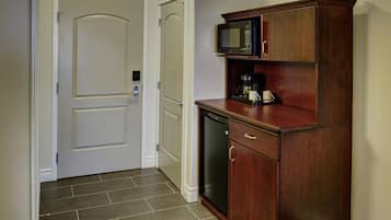 A kitchen with a microwave, coffee maker, and dishwasher.