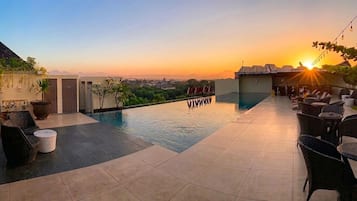 Outdoor pool, open 7:00 AM to 9:00 PM, pool umbrellas, pool loungers