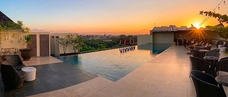 Outdoor pool, open 7:00 AM to 9:00 PM, pool umbrellas, sun loungers