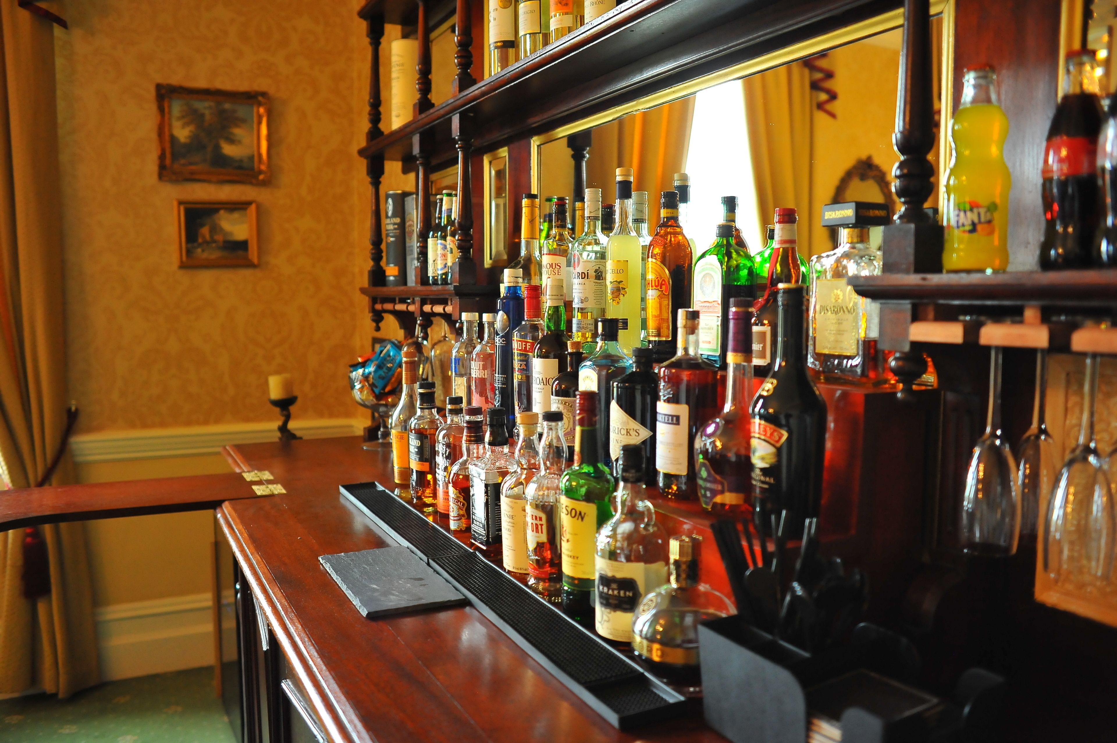 A bar with a variety of liquor bottles and glasses.