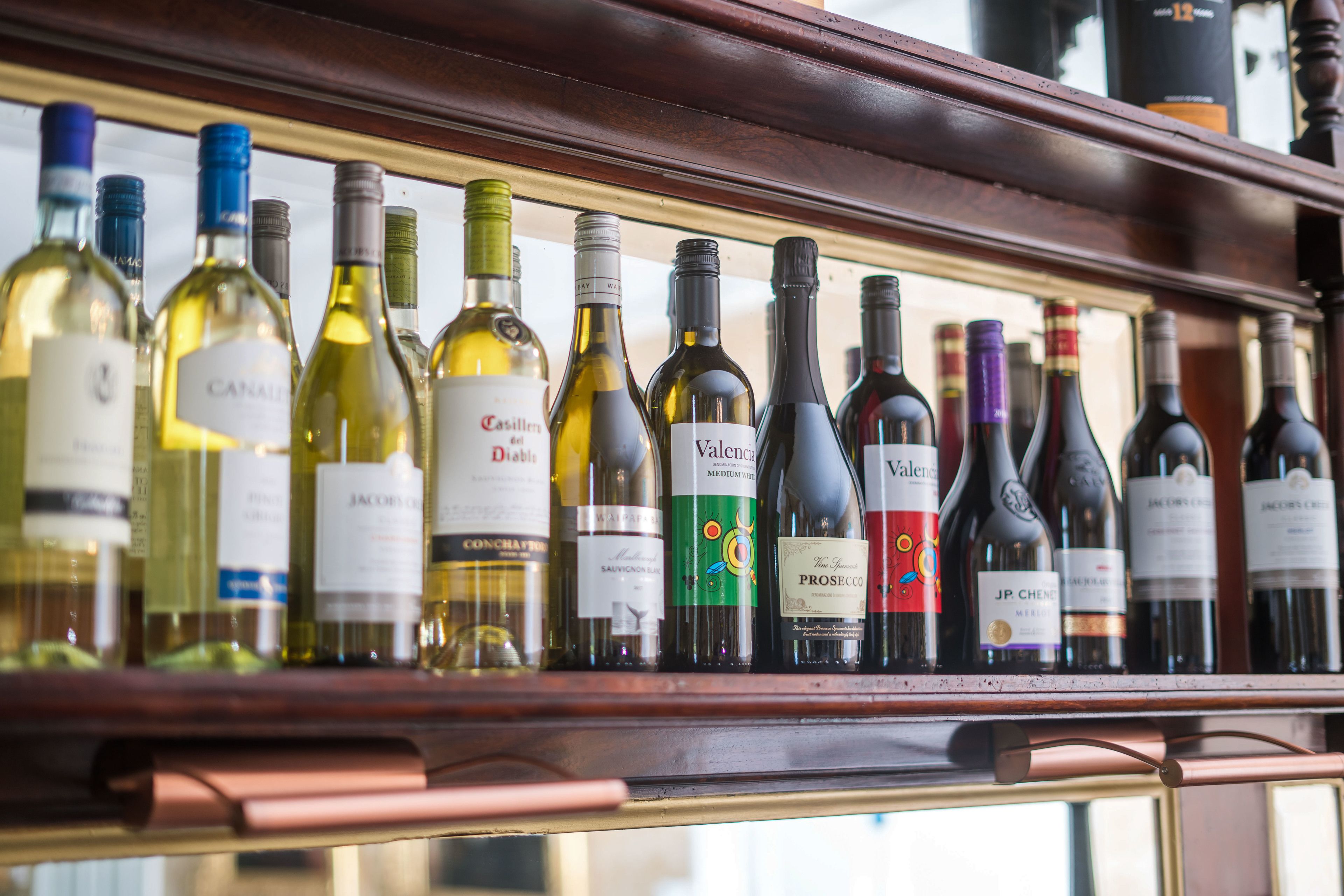 A wine rack with various bottles of wine.