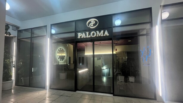 A modern building with a glass facade and the sign "PALOMA" above the entrance. - Paloma (Athens)