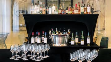 A bar area with a variety of liquor bottles and glasses.