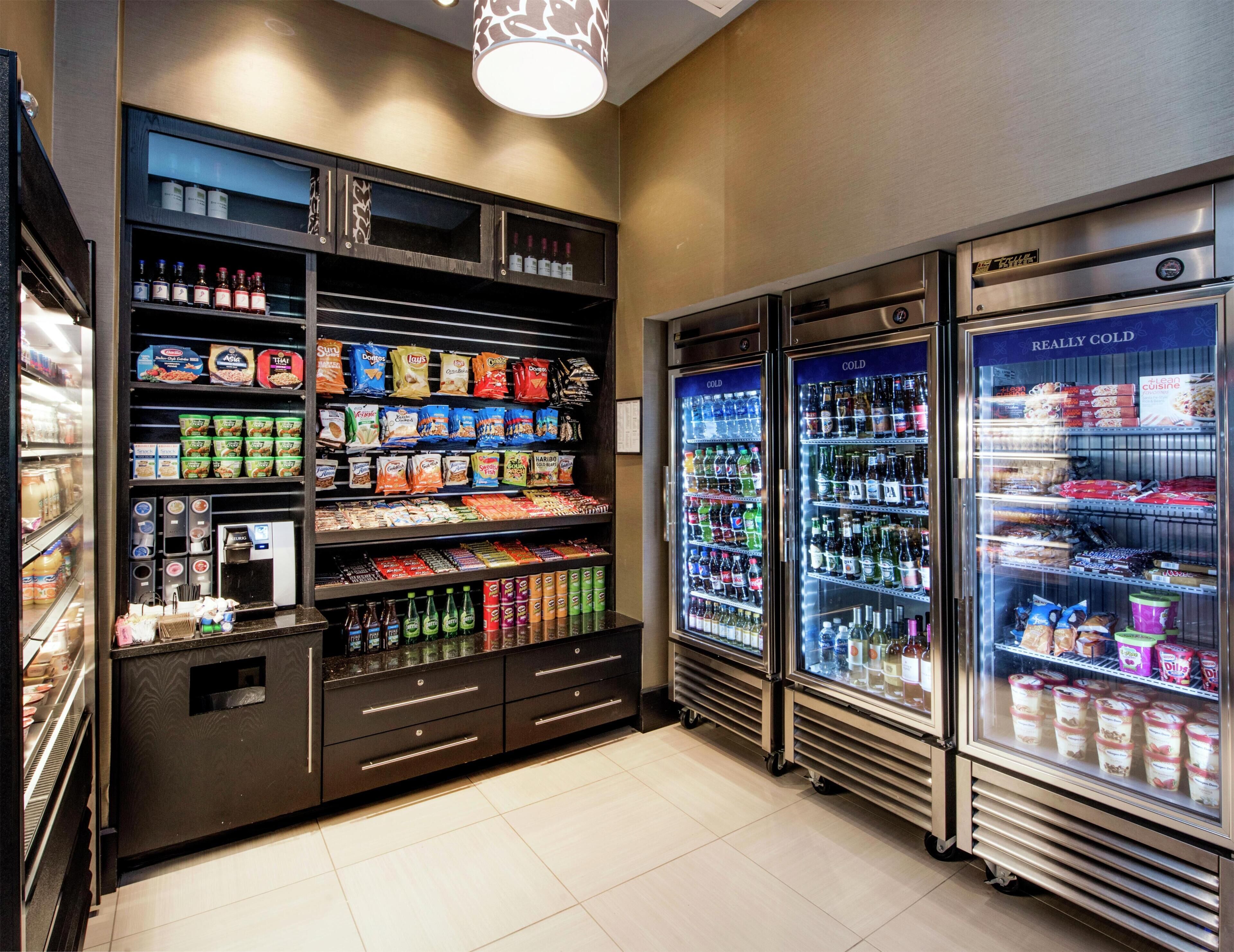 A refrigerated beverage and snack display area in a hotel.