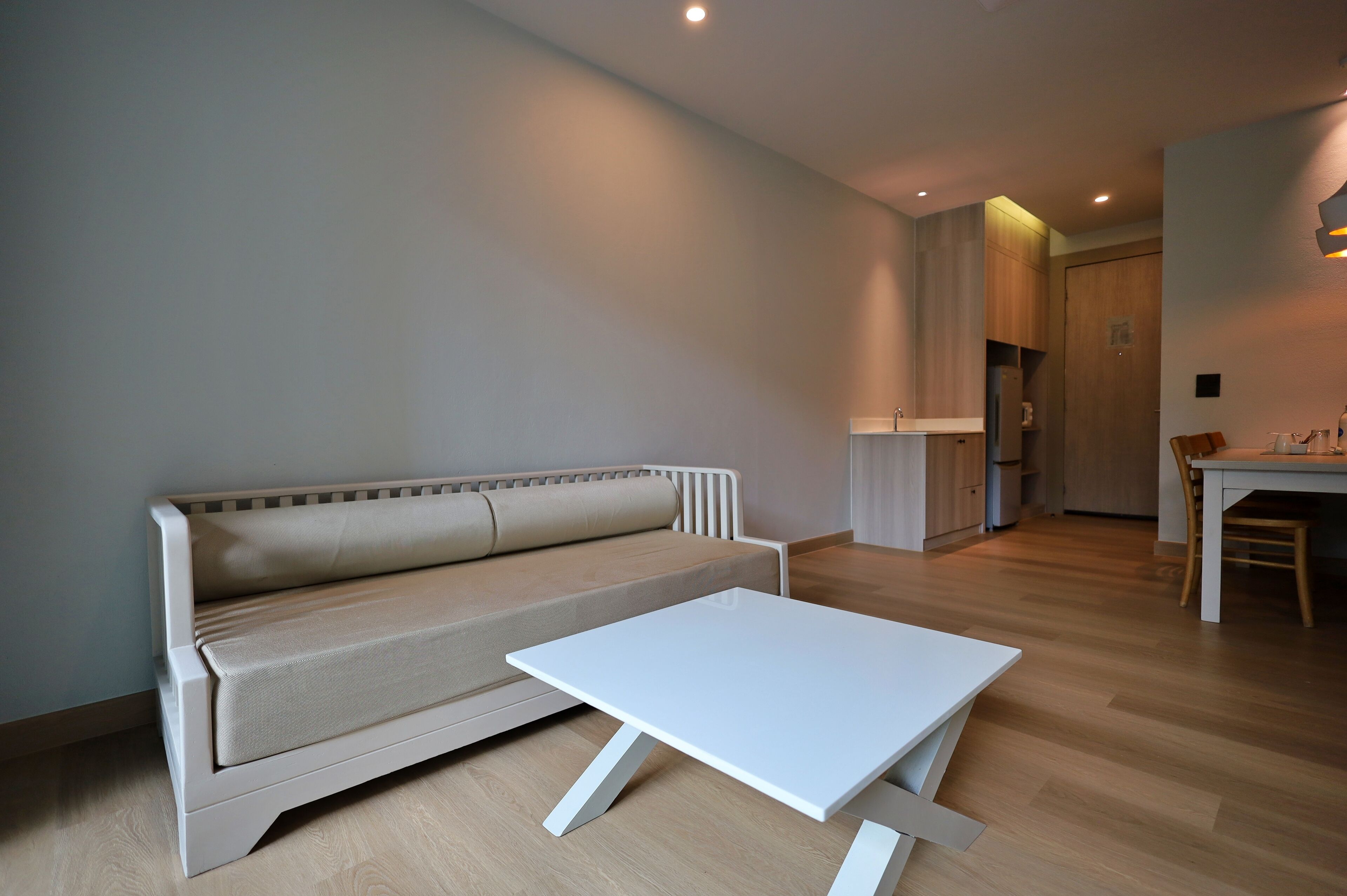 A modern living room with a sofa and a white coffee table.