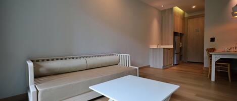 A modern living room with a sofa and a white coffee table.