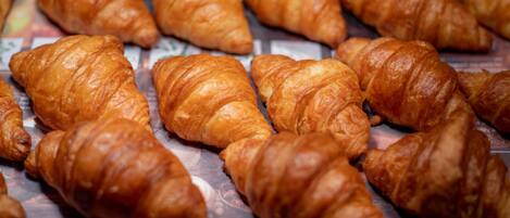 A display of golden-brown croissants arranged on a tray.