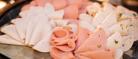 A variety of sliced meats arranged on a tray.