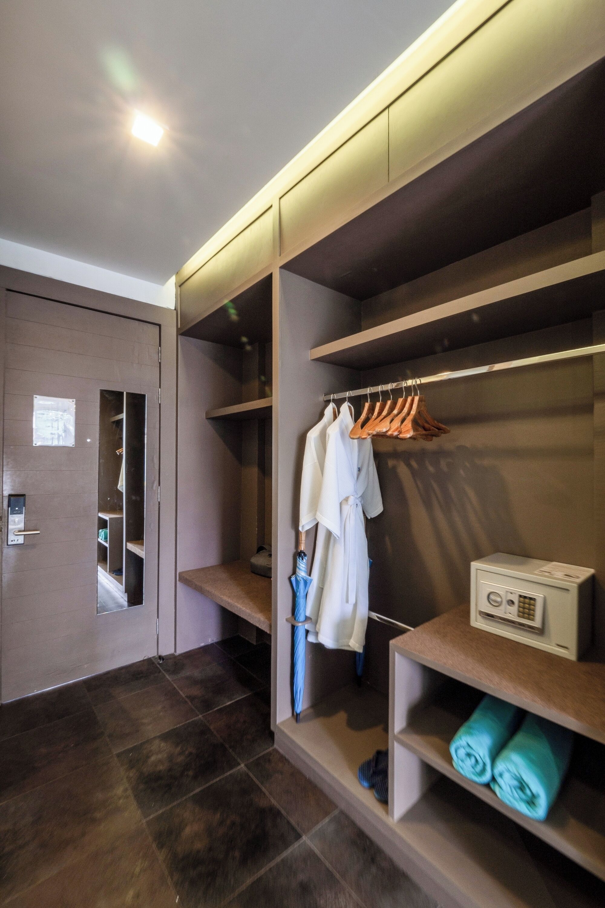 A modern bathroom with a walk-in shower, a vanity with a mirror, and a towel rack.