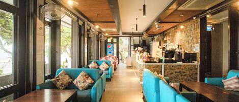 A restaurant with blue seating, a bar area, and a visible Pepsi sign.