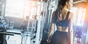 A gym with exercise equipment and a person working out. - The Yorkshire Hotel (Patong)