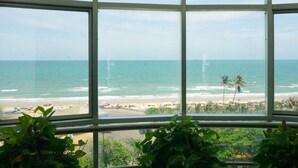 A view through a window with a beach and ocean in the background. - Green Hotel (Ho Chi Minh City)