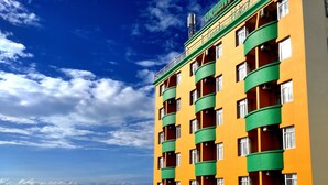 A multi-story hotel with balconies and a view of the ocean. - Green Hotel (Ho Chi Minh City)