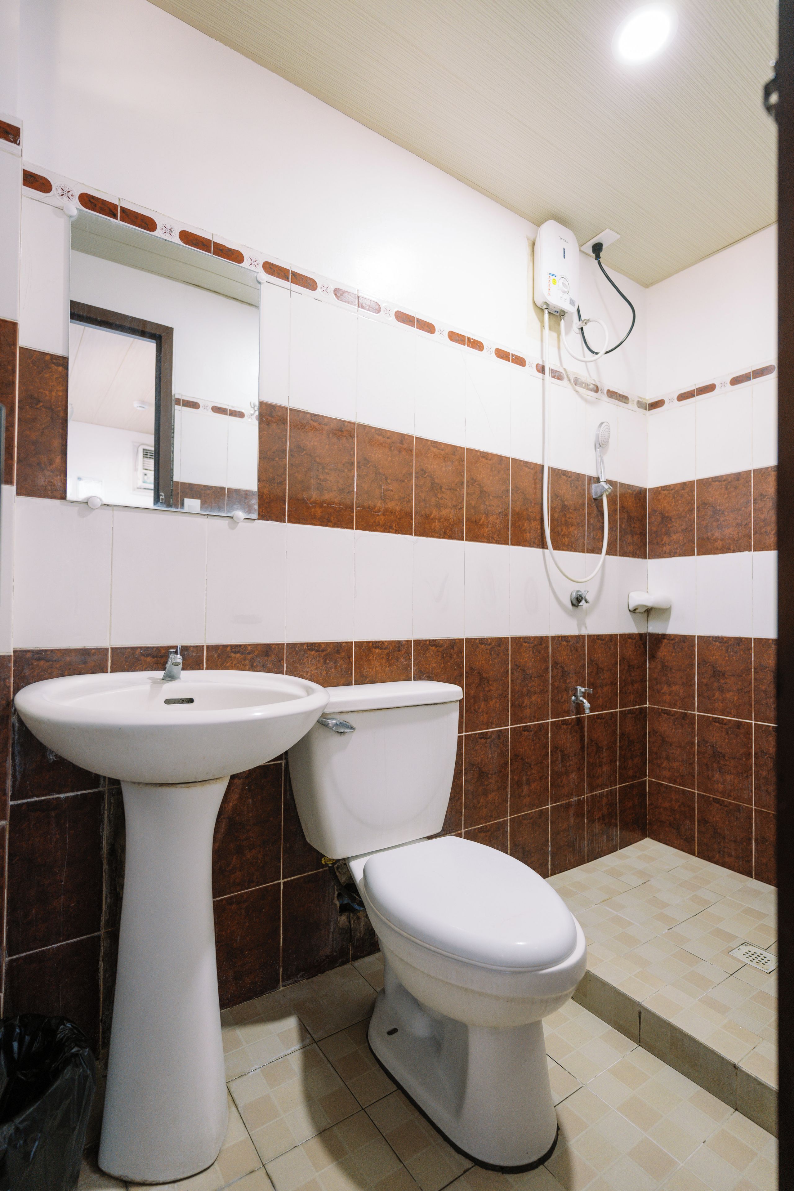 A bathroom with a white sink, a toilet, and a shower.