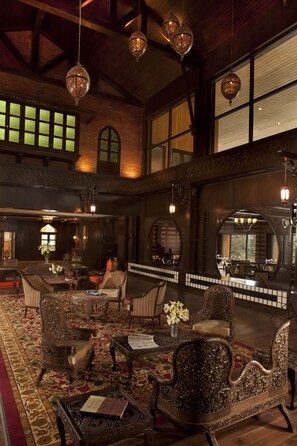 A spacious lobby with ornate furniture, large windows, and hanging chandeliers. - The Khyber Himalayan Resort & Spa (Baramula)
