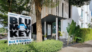 A sign for 'Blu Monkey' with a 'Bed & Breakfast' service, contact number, and a friendly monkey illustration. - Blu Monkey Bed & Breakfast Phuket (Phuket)
