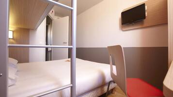 A bunk bed with a TV mounted on the wall above it.