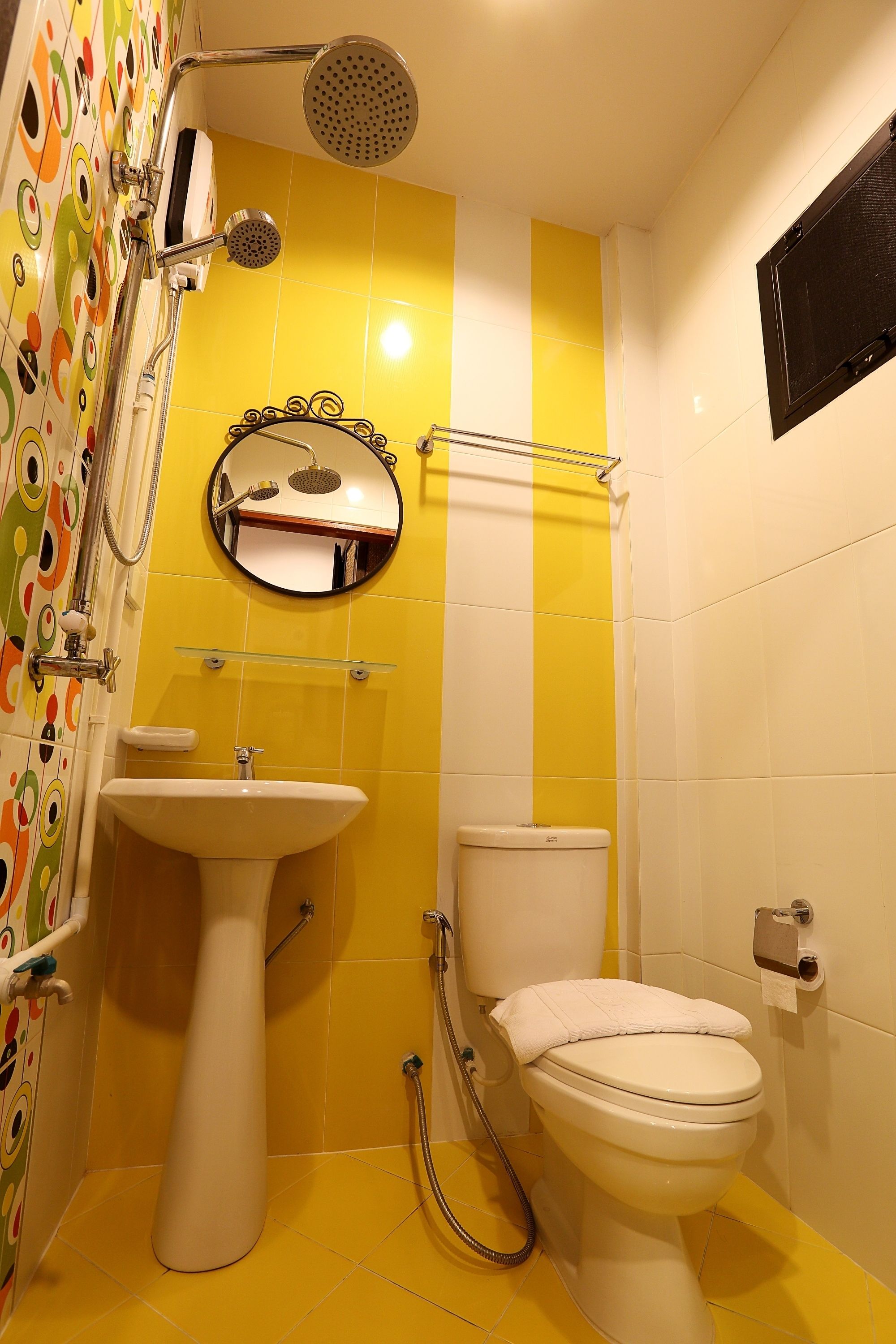 A bathroom with a toilet, sink, and shower.