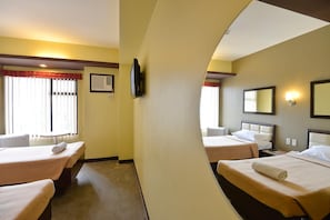 A hotel room with two beds, a television, a mirror, and a window with curtains. - Express Inn - Cebu Hotel (Cebu City)