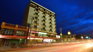 A multi-story building with a flat facade, several balconies, and a ground-level commercial area with shops. - Express Inn - Cebu Hotel (Cebu City)