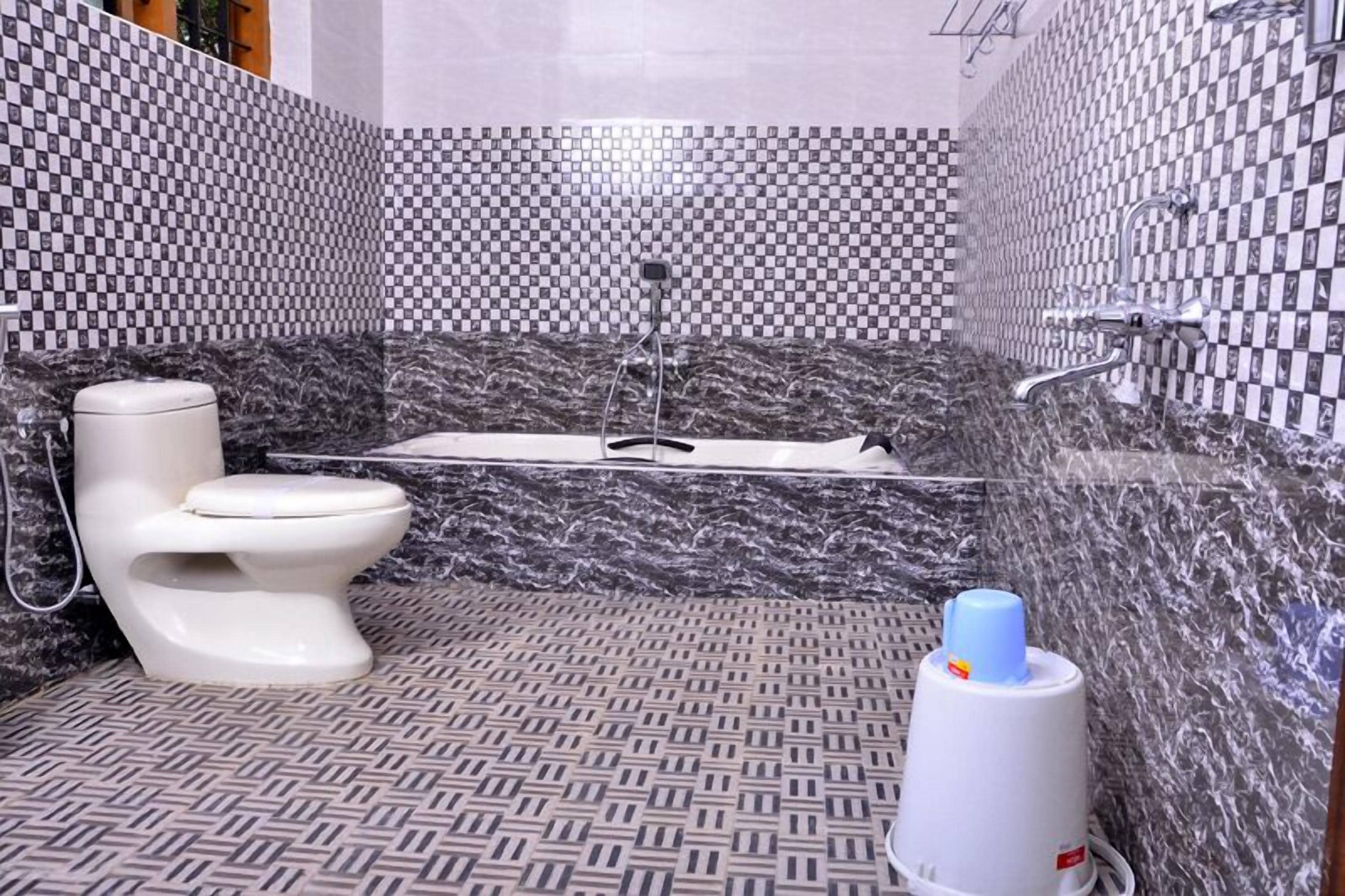 A bathroom with a toilet, a bathtub, and a shower.
