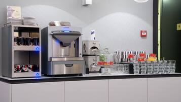 A self-service beverage station with a coffee machine, water dispenser, and a Peece coffee dispenser.