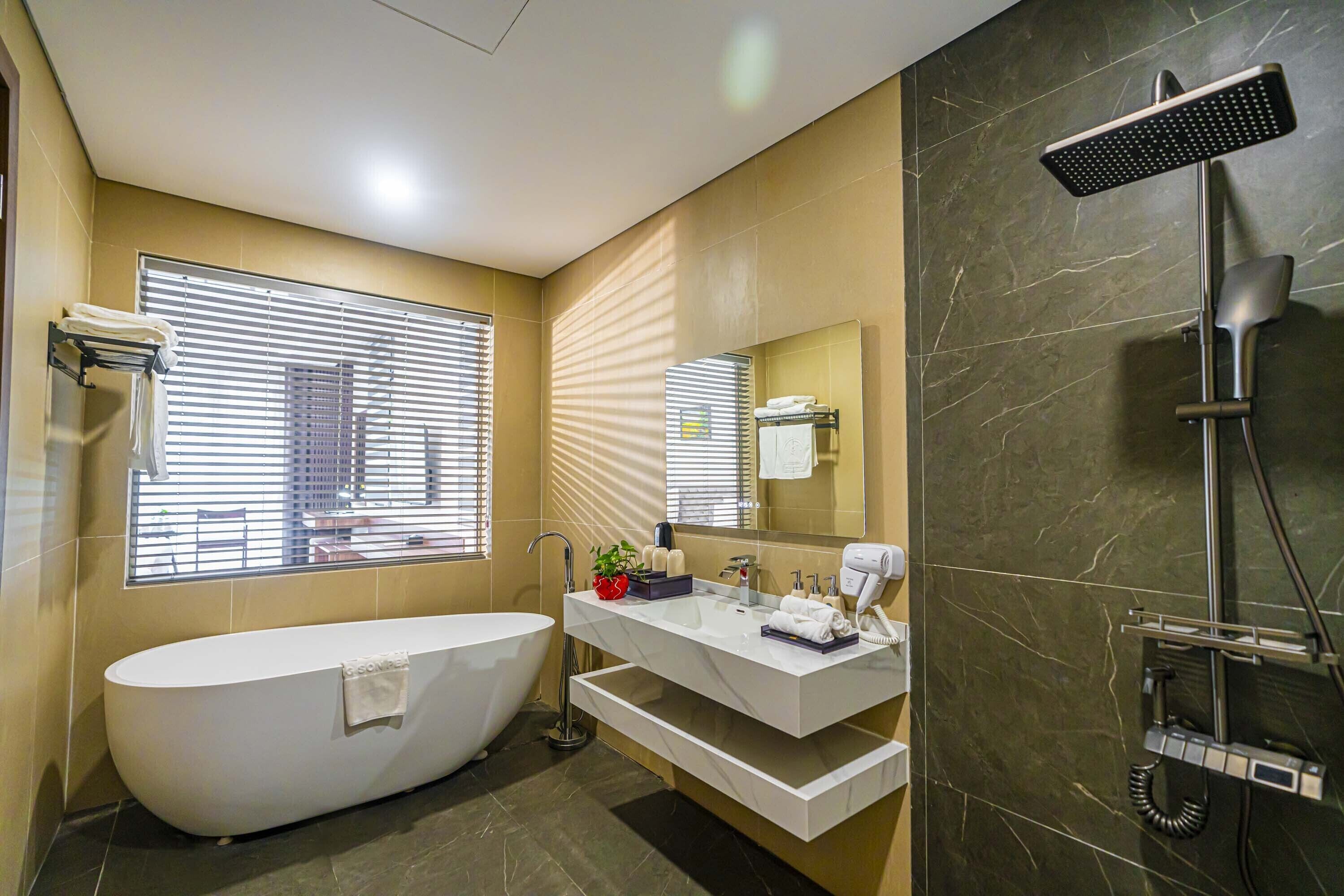 deep-soaking bathtub, hydromassage showerhead, designer toiletries