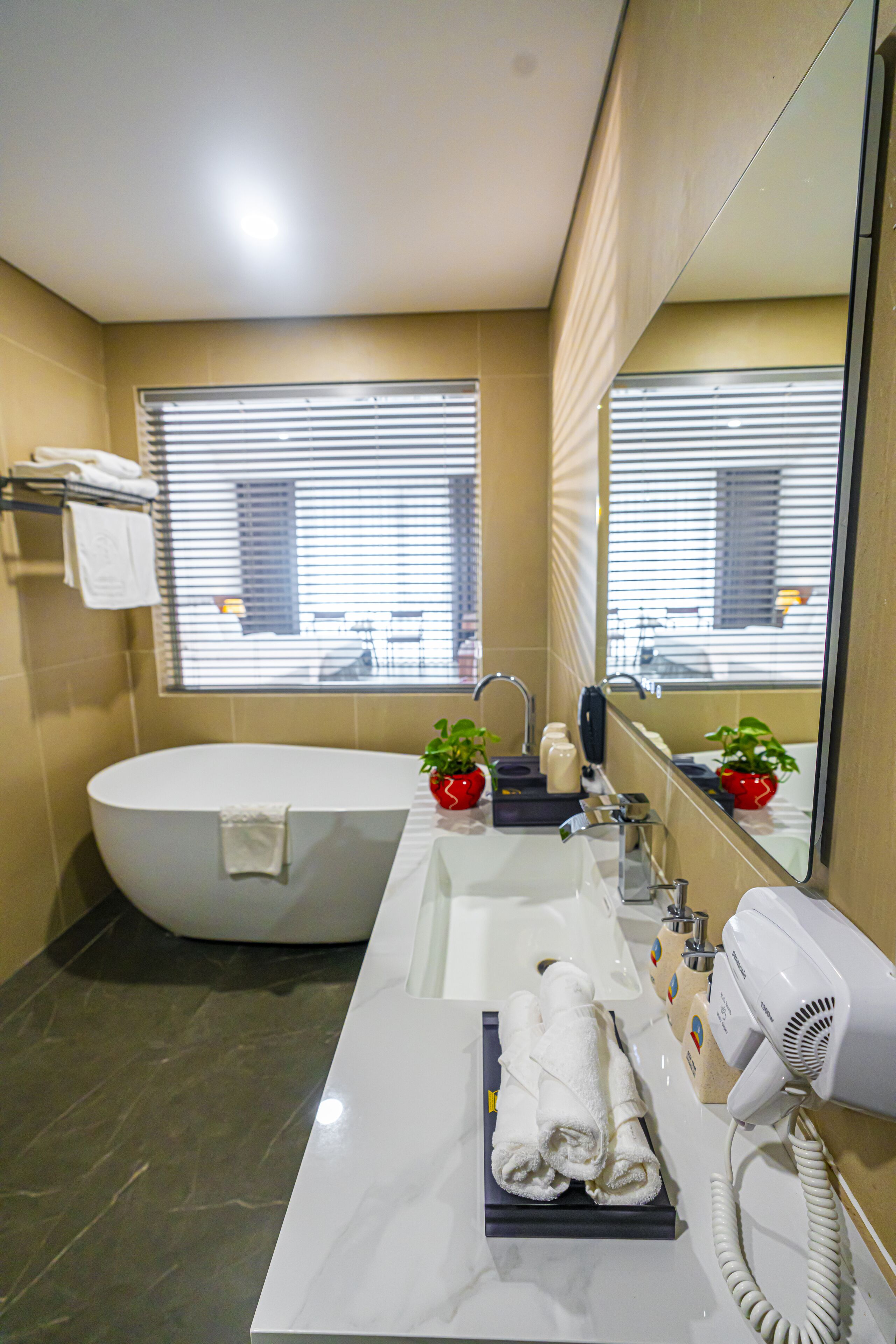 deep-soaking bathtub, hydromassage showerhead, designer toiletries