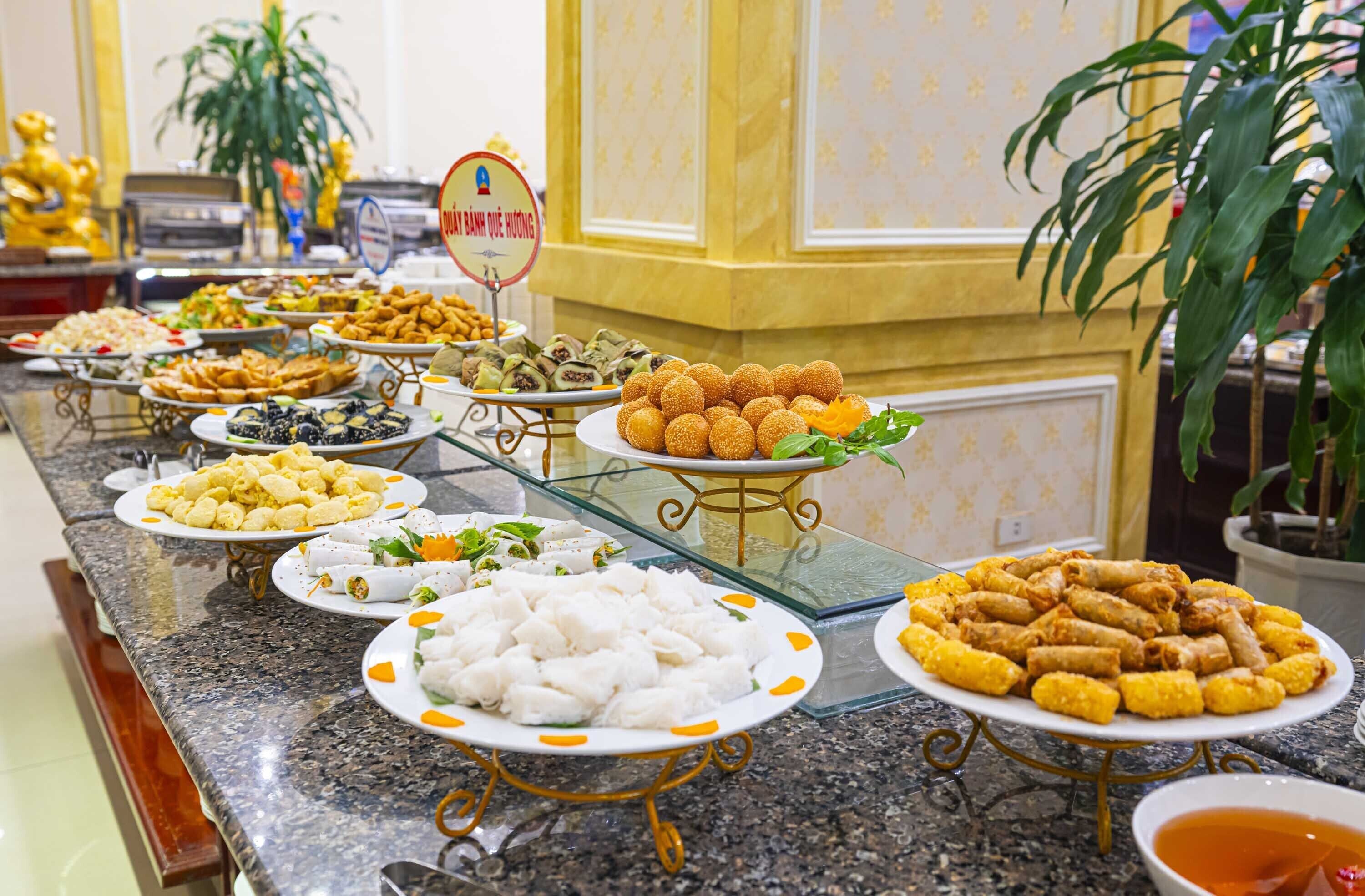 A buffet with various dishes including fried items and desserts.