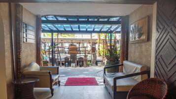 Eine Lobby mit Glasdecke, einer Rezeption und Sitzbereichen.