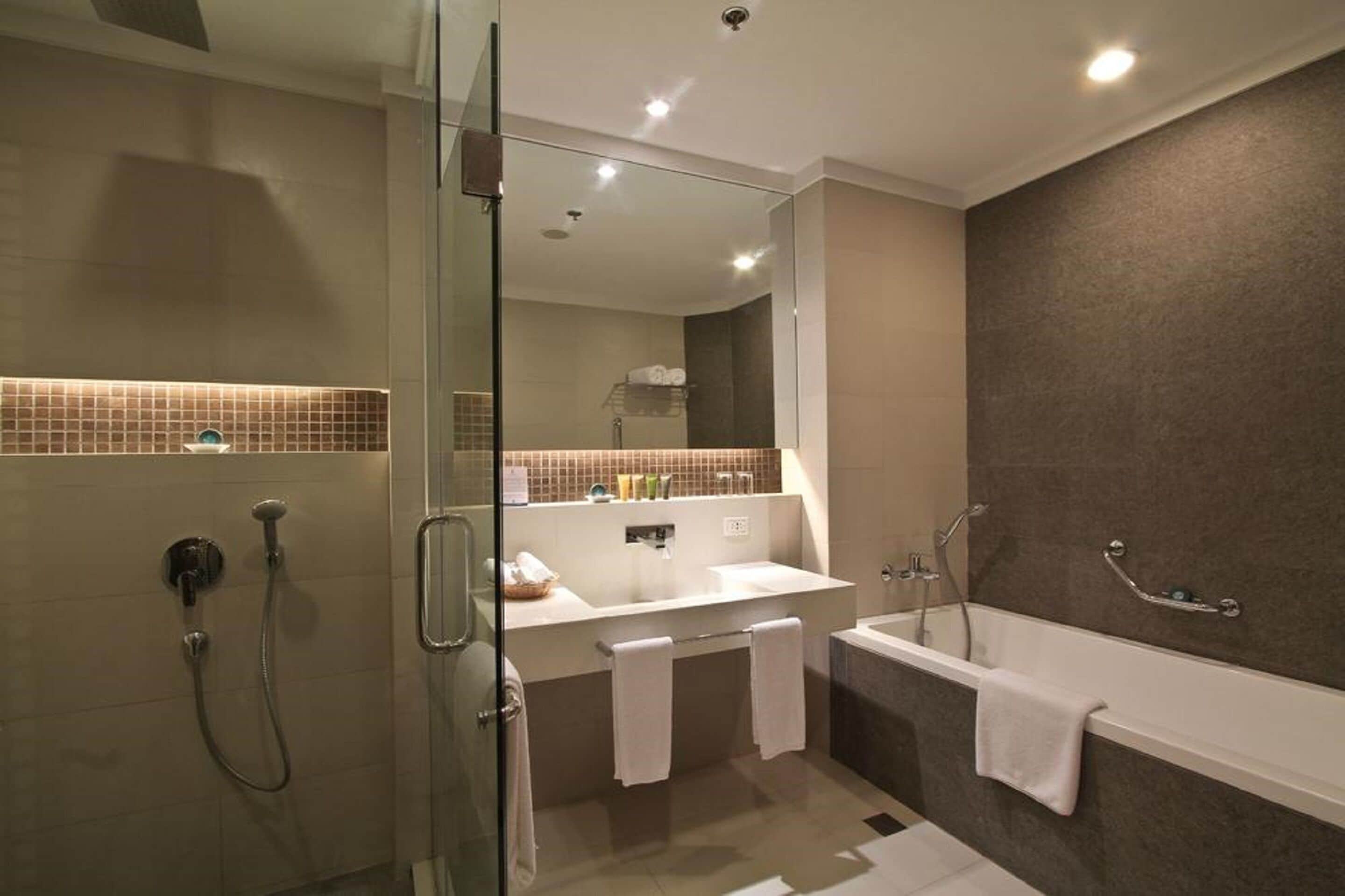 junior suite, non smoking | bathroom | separate bathtub and shower, rainfall showerhead, free toiletries