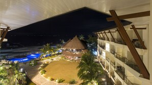 A resort with a pool, a thatched-roof building, and a beach. - The Bellevue Resort (Panglao)
