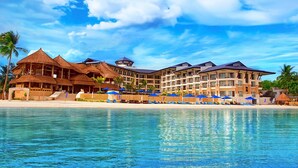 A resort with multiple buildings, a beach, and a pool. - The Bellevue Resort (Panglao)