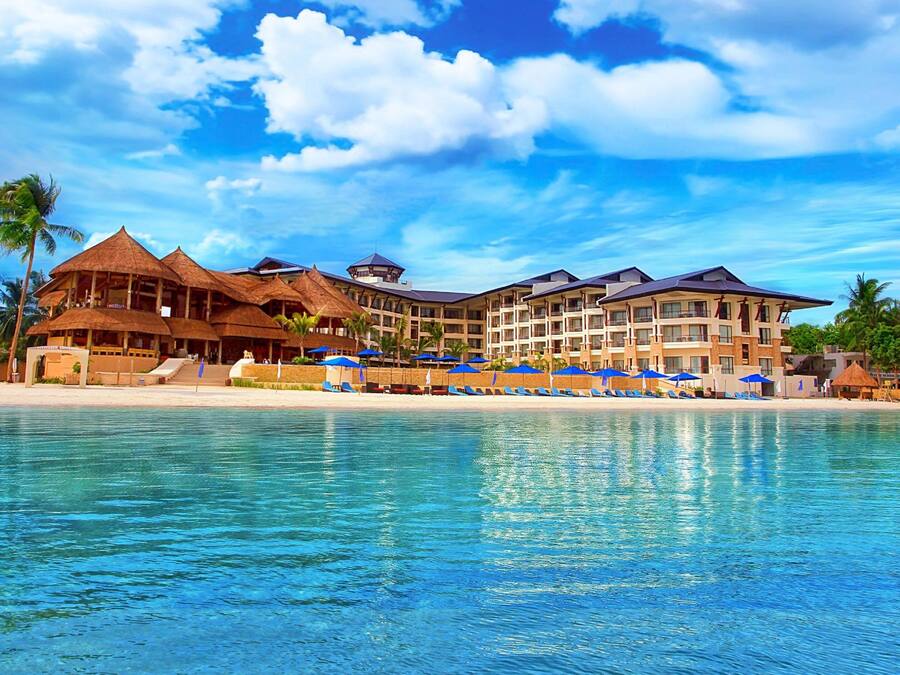 On the beach, white sand, sun-loungers, beach umbrellas
