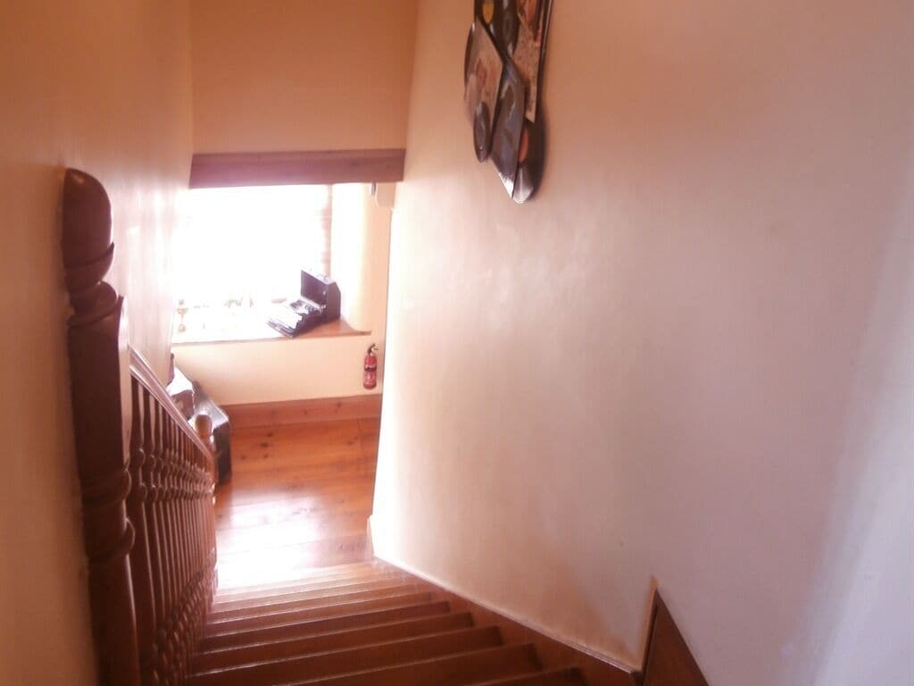 A staircase with wooden steps leading to a landing.