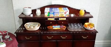 A buffet setup with various food items and beverages.