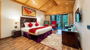A spacious bedroom with a large bed, wooden ceiling, and a view of the outdoors.