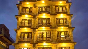 A multi-story hotel with balconies and a well-lit entrance. - Hotel Tara (Pokhara)