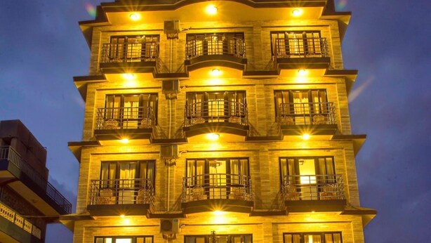 A multi-story hotel with balconies and a well-lit entrance. - Hotel Tara (Pokhara)