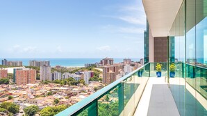 A high-rise building with a glass balcony overlooking a coastal cityscape. - Sotero Hotel (Salvador)